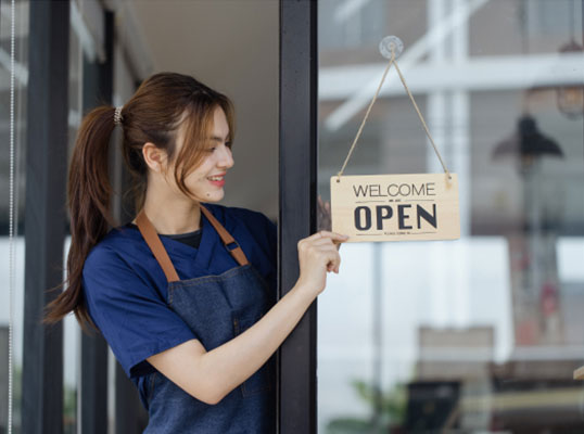 employee turning the door sign to 