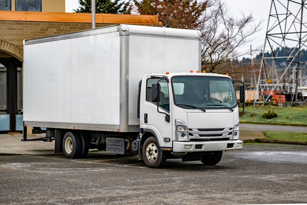 White box truck parked on road