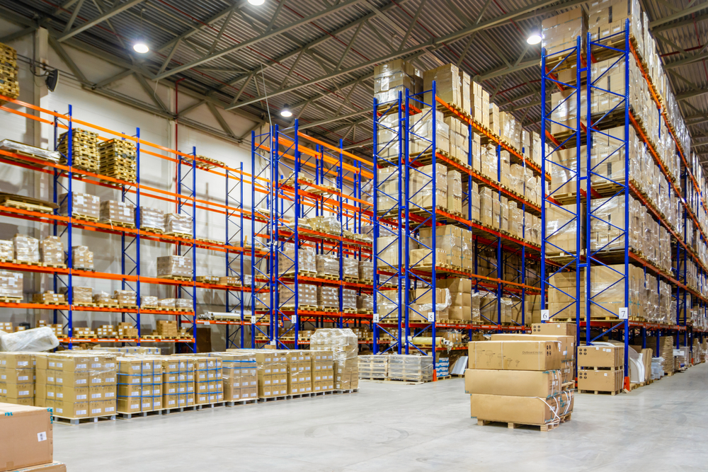 Warehouse interior stacked with racks and boxes.